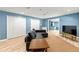 Finished basement featuring storage closets, wood flooring, and comfortable seating at 3052 Fleet Sw St, Marietta, GA 30064