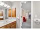 Bathroom with wooden vanity, bright lights and hallway access at 3052 Fleet Sw St, Marietta, GA 30064