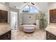 Bright bathroom featuring a soaking tub, glass shower, granite counters, and plenty of storage space at 3052 Fleet Sw St, Marietta, GA 30064