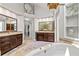 Spacious bathroom featuring double sinks, granite counters, soaking tub, and glass shower at 3052 Fleet Sw St, Marietta, GA 30064