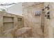 Tiled shower featuring shampoo niche, built-in seat, and rainfall shower head at 3052 Fleet Sw St, Marietta, GA 30064