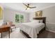 Comfortable bedroom featuring neutral decor, a large window, and a ceiling fan at 3052 Fleet Sw St, Marietta, GA 30064