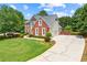 Sprawling home featuring a large driveway and lush landscaping at 3052 Fleet Sw St, Marietta, GA 30064