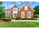 Charming red brick home featuring manicured landscaping and a beautiful bay window at 3052 Fleet Sw St, Marietta, GA 30064