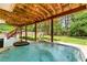 Relax in this backyard hot tub with wood beam cover, string lights, and view of the well-manicured backyard at 3052 Fleet Sw St, Marietta, GA 30064