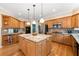 Updated kitchen features stainless steel appliances, light granite countertops, a large island, and custom wood cabinets at 3052 Fleet Sw St, Marietta, GA 30064