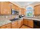 Updated kitchen features granite counters, a gas cooktop, stainless appliances, and natural light from the window at 3052 Fleet Sw St, Marietta, GA 30064