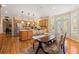 Open kitchen area features stainless appliances, hardwood floors, granite counters, an island, and a breakfast table at 3052 Fleet Sw St, Marietta, GA 30064