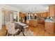Open kitchen area features stainless appliances, hardwood floors, granite counters, an island, and a breakfast table at 3052 Fleet Sw St, Marietta, GA 30064