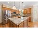 Bright kitchen boasts stainless steel appliances, granite countertops, a center island, and natural wood cabinets at 3052 Fleet Sw St, Marietta, GA 30064