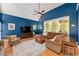 Cozy living room with blue walls, hardwood floors, neutral rug, and comfortable seating at 3052 Fleet Sw St, Marietta, GA 30064