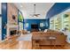 Bright living room with blue walls, brick fireplace, hardwood floors and custom built-ins at 3052 Fleet Sw St, Marietta, GA 30064