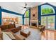 Open-concept living room with brick fireplace, hardwood floors, and adjacent kitchen at 3052 Fleet Sw St, Marietta, GA 30064