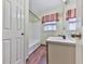 Bathroom featuring a bathtub, vanity with mirror, and red and white valance at 712 Copper Trace Way, Woodstock, GA 30189