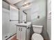 Bathroom features a walk-in shower with glass door, sink, and toilet at 712 Copper Trace Way, Woodstock, GA 30189