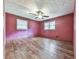 The bedroom features pink walls, wood flooring and a ceiling fan at 712 Copper Trace Way, Woodstock, GA 30189