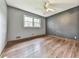 A simple bedroom with gray walls, a ceiling fan, and wood floors at 712 Copper Trace Way, Woodstock, GA 30189