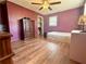 Bedroom with laminate flooring, ceiling fan, bed, desk, and closet at 712 Copper Trace Way, Woodstock, GA 30189