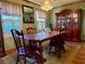 Elegant dining room with hutch, wood table, chandelier and shuttered windows, great for gatherings at 712 Copper Trace Way, Woodstock, GA 30189