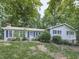 Charming home featuring blue shutters and a mature landscape offering shade and curb appeal at 712 Copper Trace Way, Woodstock, GA 30189