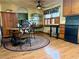 Kitchen boasts wood cabinets, a round dining table, and a stylish baker's rack, perfect for entertaining at 712 Copper Trace Way, Woodstock, GA 30189