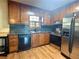 Traditional kitchen featuring wood cabinets, stainless steel appliances, and laminate countertops at 712 Copper Trace Way, Woodstock, GA 30189