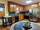 Kitchen features wood cabinets, stainless steel appliances, and a round table for casual dining at 712 Copper Trace Way, Woodstock, GA 30189