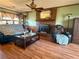 Cozy living room showcasing a brick fireplace, hardwood floors, and comfortable seating at 712 Copper Trace Way, Woodstock, GA 30189