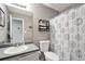 Clean bathroom with sink, toilet, and shower showcasing a patterned curtain at 107 Gwenellen Dr, Locust Grove, GA 30248
