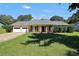 Charming single-story home with a welcoming front porch, attached garage, and a well-manicured lawn at 107 Gwenellen Dr, Locust Grove, GA 30248