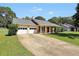 Inviting home featuring an attached garage, covered front porch, and a spacious driveway at 107 Gwenellen Dr, Locust Grove, GA 30248