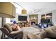 Spacious living room features a stone fireplace, large television, and comfortable seating arrangement at 107 Gwenellen Dr, Locust Grove, GA 30248