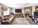 Comfortable living room featuring a stone fireplace, plush seating, and a modern ceiling fan at 107 Gwenellen Dr, Locust Grove, GA 30248