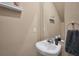 Well-lit half bathroom features modern fixtures, vanity, mirror, and wall-mounted shelves at 157 Oliver Dr, Locust Grove, GA 30248