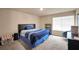 Bright bedroom featuring a large window, neutral walls, soft carpet, and simple decor at 157 Oliver Dr, Locust Grove, GA 30248