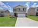 Charming two-story home featuring a two-car garage and well-maintained lawn at 157 Oliver Dr, Locust Grove, GA 30248