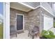 Close-up of the cozy front porch with chairs at 157 Oliver Dr, Locust Grove, GA 30248