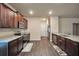 Spacious kitchen with stainless appliances, granite countertops, and sleek wood flooring at 157 Oliver Dr, Locust Grove, GA 30248