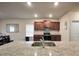 Well-equipped kitchen featuring stainless steel appliances, granite counters, and ample cabinet storage at 157 Oliver Dr, Locust Grove, GA 30248