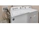 Efficient laundry area with a white washer and dryer, ensuring convenient chore management at 157 Oliver Dr, Locust Grove, GA 30248
