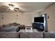 Comfortable living room with plush sectional and modern entertainment center at 157 Oliver Dr, Locust Grove, GA 30248