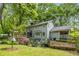 Spacious home backyard with a screened porch, patio area, and beautifully landscaped yard at 173 Price Rd, Brooks, GA 30205