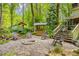 Charming backyard patio with stone pavers, fire pit, and outdoor seating next to the house at 173 Price Rd, Brooks, GA 30205