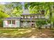 Charming two-story home features a covered front porch, red shutters, and a well-manicured lawn at 173 Price Rd, Brooks, GA 30205