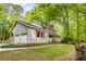 Traditional two-story home boasts a two car garage, mature trees, and an expansive front yard at 173 Price Rd, Brooks, GA 30205