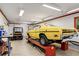Well-lit garage interior with a classic yellow car on a lift and ample workspace at 173 Price Rd, Brooks, GA 30205