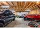 Large garage interior featuring a truck, boat, lawnmower and tall ceilings with exposed wood beams at 173 Price Rd, Brooks, GA 30205