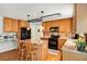 Stylish kitchen with stainless steel appliances, granite countertops, wooden cabinetry, and an island with seating at 173 Price Rd, Brooks, GA 30205