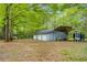 Spacious outbuilding with multiple garage doors and a covered carport area on a large lot at 173 Price Rd, Brooks, GA 30205