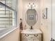 Charming powder room with vanity and decorative mirror near window at 173 Price Rd, Brooks, GA 30205